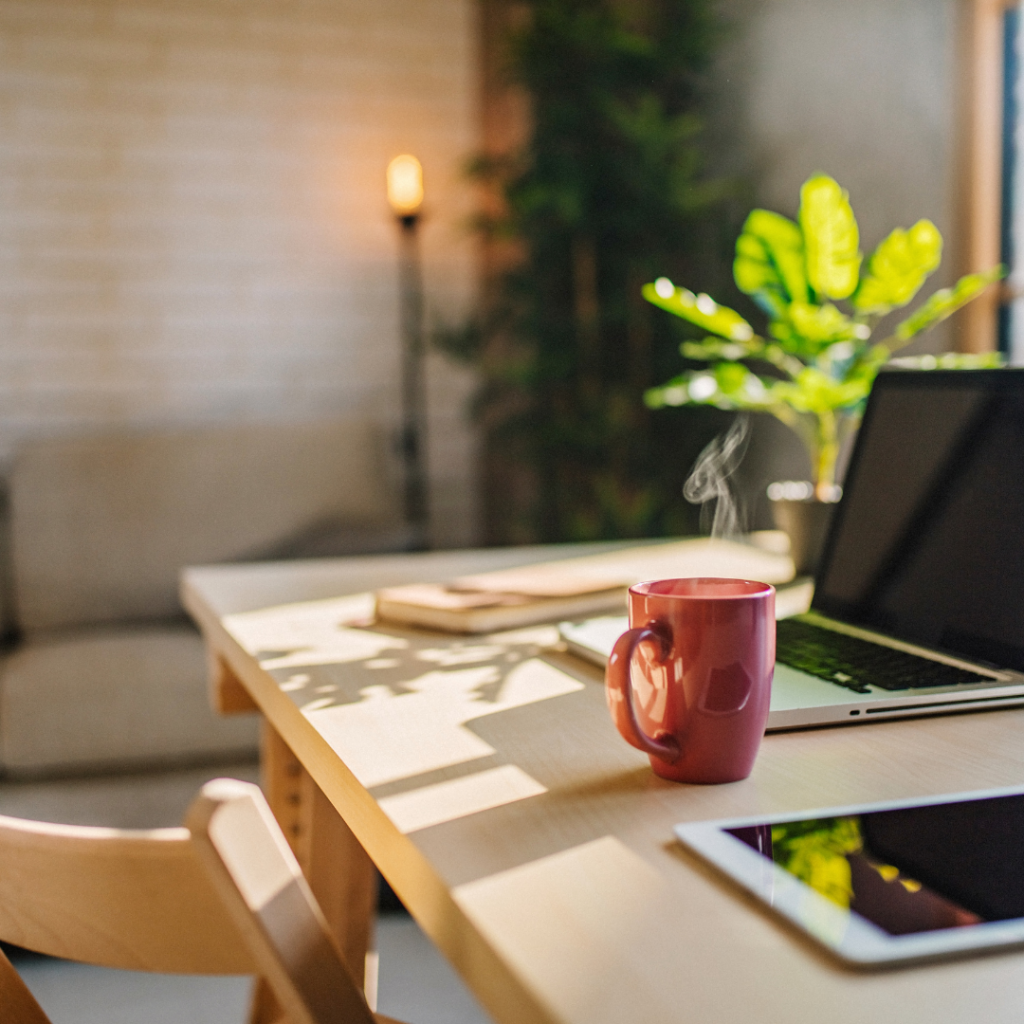 Remote working desk in home office with a laptop and coffee mug